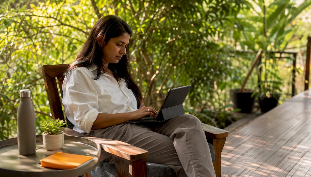 Woman typing on keyboard at home office desk