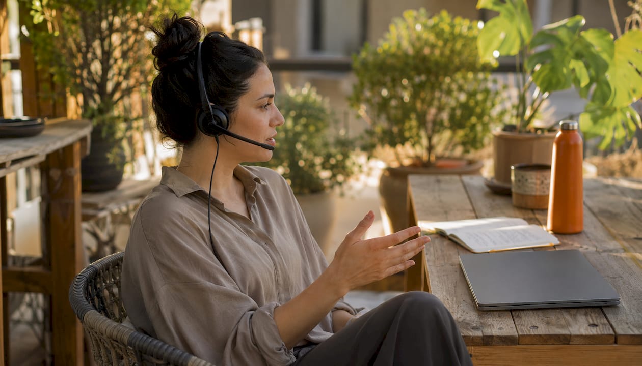 Support agent talking on headset at office